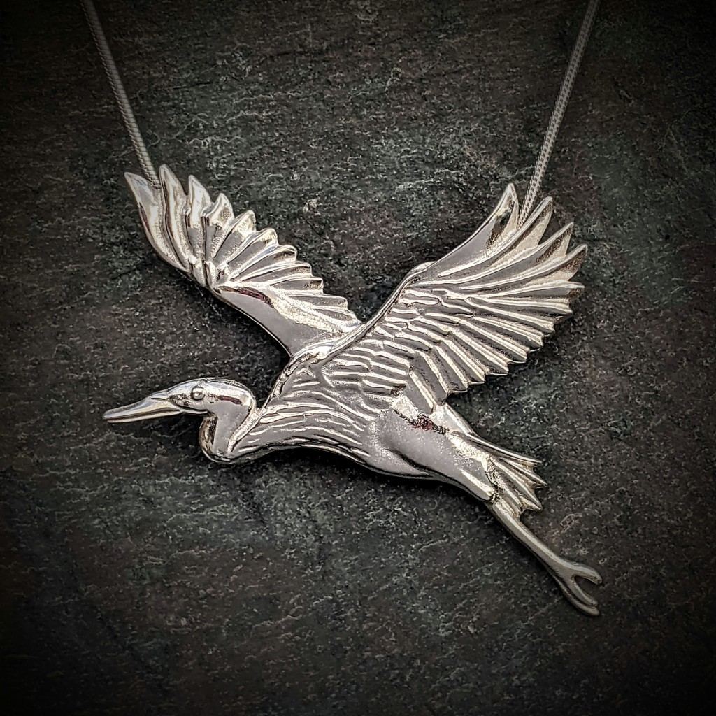 silver heron in flight